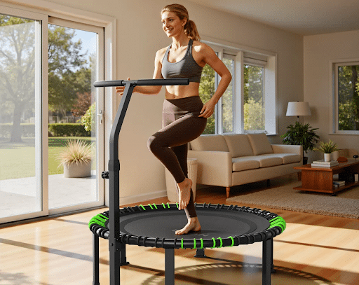Woman in workout clothes standing on a mini-trampoline in a sunlit living room, preparing to bounce exercise routine.