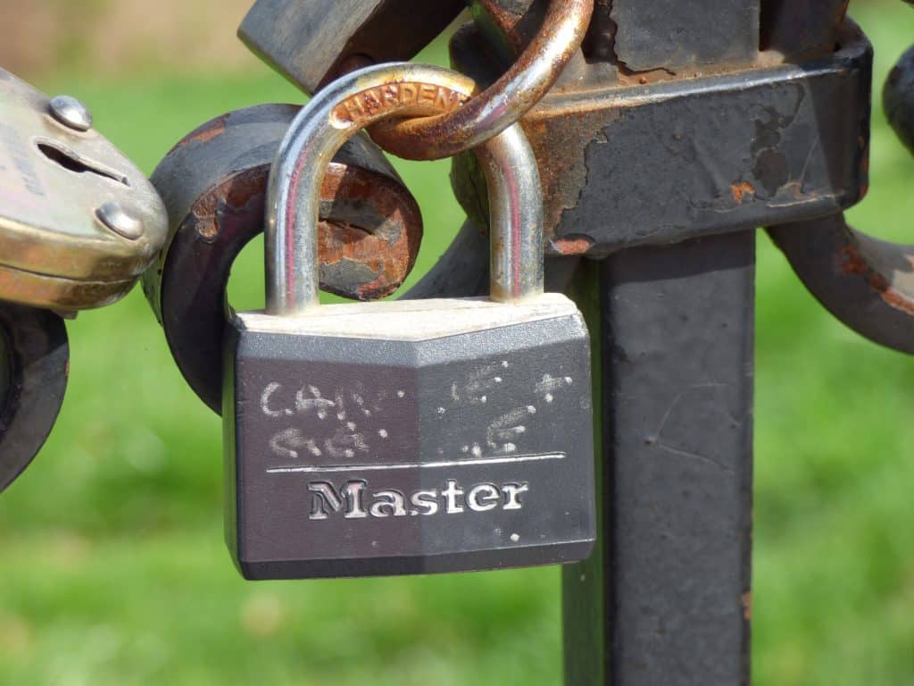 MagSafe Cases That Stay Aligned: Slip-Resistant Picks for Everyday Use (2026) Close-up of a rusty padlock with a chain looped through a metal latch; 'Master' lock body visible.